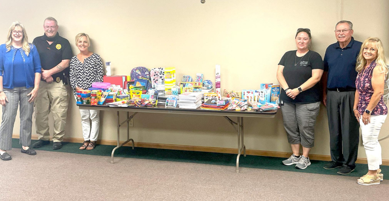 PRESENTING STOCKTON USD 271 with school supplies collected by the employees of the Stockton Correctional Facility were (from left): Marcie Diaz, Randy Dues, correctional manager Theresa Glendening, Barbara Ard, USD 271 superintendent Bill Lowry and district clerk Annette Look.