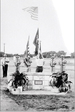 PRIOR TO THE 1989 MICKEY GILLEY CONCERT on the Thursday night of the Rooks County Free Fair, a flag pole and monument was dedicated to the late J. O. “Jimmie” Copper for the extra hours he donated to the success of the Fair for many years. Shown is the Stockton VFW Post #8873 raising the American and MIA flags.