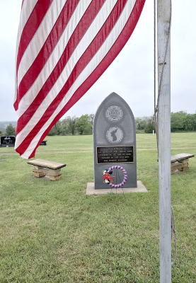 IN HONOR OF OUR HEROES, our flag waves proudly before the Veterans Memorial at the St. Thomas Cemetery on Memorial Day, a symbol of bravery, sacrifice, and enduring freedom.