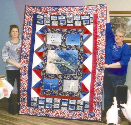 MSGT JENNY D. DIX returning from deployment to South Korea, was presented a Quilt of Honor by her cousin, Joyce Kinsley. Several family members attended to enjoy the presentation as Joyce explained the meaning of the quilt, which she had made especially for Jenny. Joyce previously presented Quilts of Valor to four family members: Jenny’s mother, Nancy Dix, her Uncle Pat Haskett; Uncle Gerald Haskett; and Aunt Judy Holloway. Jenny is the daughter of Larry and Nancy Dix, Agra.