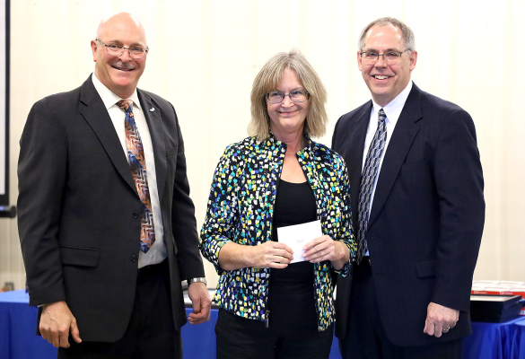 MARY WISE, (center), DSNWK Kid-Link Coordinator in the Stockton office, was among those who received an award at the annual awards luncheon in Hays on October 18th. Mary has been working for DSNWK for 40 years. With her for the award presentation was Jerry Michaud, left, DSNWK President and Andy Beck, right, DSNWK Board Member.