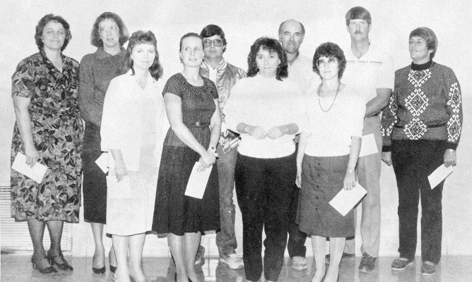 LEADERS who received five and ten year awards at the Rooks County 4-H Achievement Banquet in 1989 were (front row, from left) Beth Jones, Linda Stamper, Jane Lambert, Marla Darnell; (back row) Ruth Ann Bigge, Pam Jakoplic, Harry Colburn, Jimmy Jackson, Will Stout, and Darlene Jones.