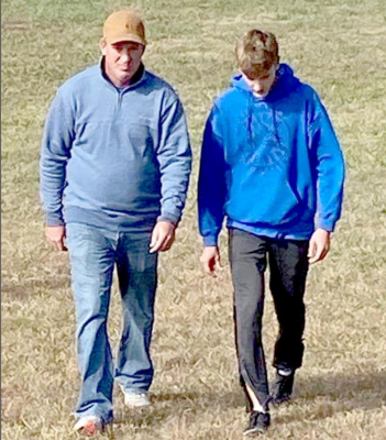 COACH CHRIS GRAHAM gives Jonny Hamel instructions prior to the Regional race held at Centralia City Lake. (Courtesy Photo)