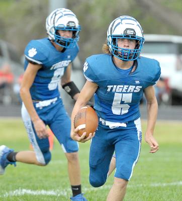 EMERSON LOWRY finds some running room during the Tigers’ game with Logan/Palco last Friday. In the background is quarterback Max Moffet.