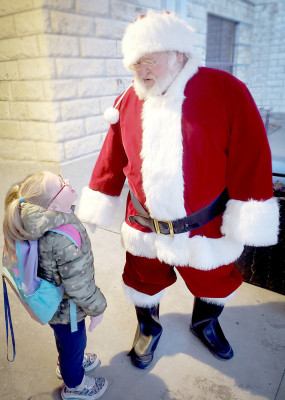 GRACE TOWNE met up with Santa, who has very special ties to the family, on Friday, December 15th, during the Stockton Grade School’s High Five Friday.