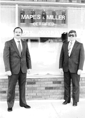 JOHN MAPES (left) and Denis Miller (right) are standing in front of their recently remodeled offices in the building formerly occupied by Stockton's florist. The Stockton Chamber of Commerce held a ribbon-cutting ceremony on December 18th, 1989, at the Mapes and Miller location. Refreshments were served to the many who toured the offices.