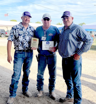 ROYCE MUIR (middle) was inducted into the Kansas Fairs and Festivals Hall of Fame, and was recognized for his years of service from 1984 to 2021 as a board member and president. Royce was not able to attend the annual banquet in January of this year, but received his award at the Rooks County Free Fair. Royce said it made it even more special to be able to accept the award with all his family and fair friends present. Pictured are board member Cade Beesley, Royce Muir, and fair president Dean Hrabe.