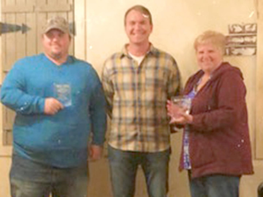 JEFF KELLER, left, and Pam Rudman, right, two employees at Keller Motors in Palco, were recently recognized by owner, Myron Keller, center. Both employees have worked for 20 years at Keller Motors.