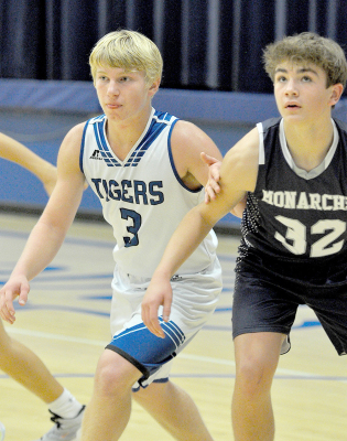 ISAAC THAYER fights for rebound position during a free throw attempt in the Tigers’ game against the TMP Monarchs.