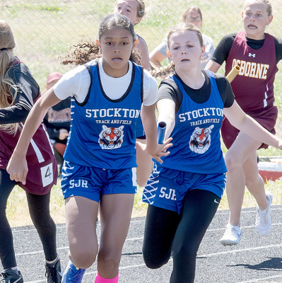 Remy Muir handing off to Ava McCoy in 4 x 1 Relay — SJH Meet