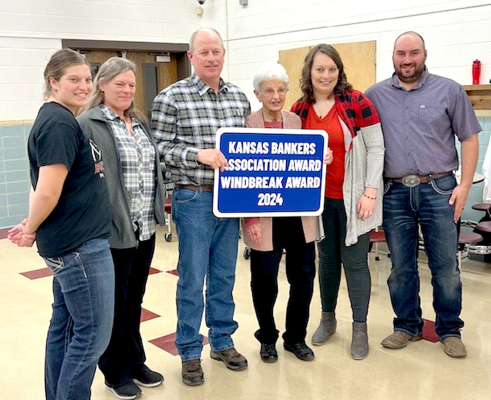 THE 2024WINDBREAK AWARD goes to Barbara Griffin and the late David Griffin of Natoma. Receiving the award at this year’s Annual Meeting of the Rooks County Conservation District on Monday, January 27th, at the Plainville Grade School included, from left: Shandra Griffin, Lorie Griffin, Tim Griffin (son of the late David Griffin), Barbara Griffin, Shayla Goossen, and Lucas Goossen.