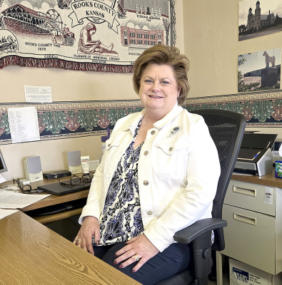 JEANINE MCKENNA at her desk in the Rooks County Economic Development Office, ready to help grow and support the Rooks County communities.