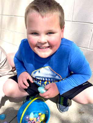 TRENT LOOK checks out the candy and eggs he collected during the annual Sigma Phi ESA Easter Egg Hunt held at Stockton’s Lower City Park on Saturday, March 30th.