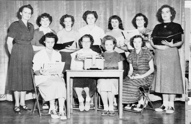 THE 1951 CARDINALYEARBOOK STAFF were (front row from left to right) Pauline Fellhoelter, Marilyn Cerrow, Zelda Wildrix, Thelma Phlieger; (back row) sponsor Mrs. Lola Overholser, Peggy Pemberton, Lucille Stahl, Bernadine Rempe, Betty Adam, Yvonne LeGesse, and Shirley Benedick. Also part of the staff was Champ Matson, who was not present for the picture. The 1951 Cardinal was dedication to Mrs. Overholser.