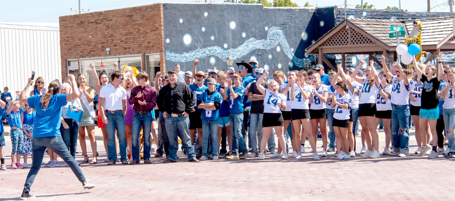 DR. ANGELA MCCOLLUM gets the students pumped up during the Homecoming Parade held on Main Street last Friday.