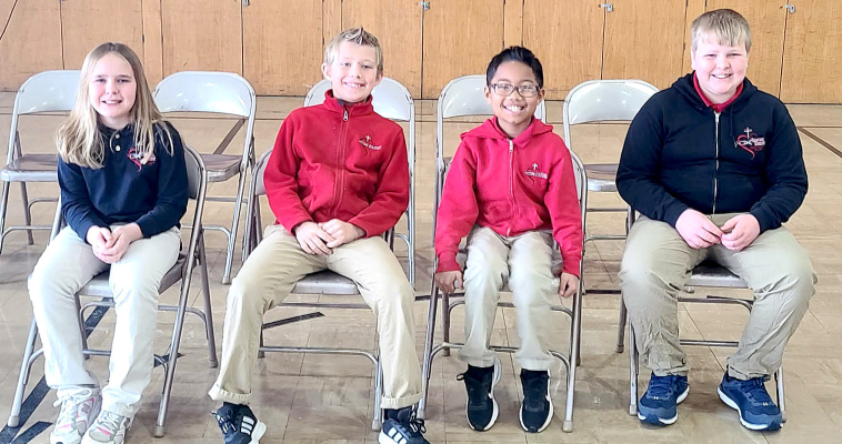 REPRESENTING SACRED HEART at the Rooks County Spelling Bee on Tuesday, February 3rd, at Plainville were (from left) Ruthie Brewster (fourth place), Jack Hillard (third place), Jesse Akoh (second place), and Max Brewster (first place).