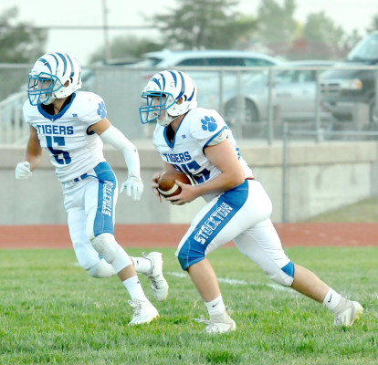 TIGER SENIOR JUSTUS HULSE returns the opening kickoff of the Tigers’ game with the Hill City Ringnecks last Friday night at Hill City. His teammate Justin Knoll is looking to block for him.