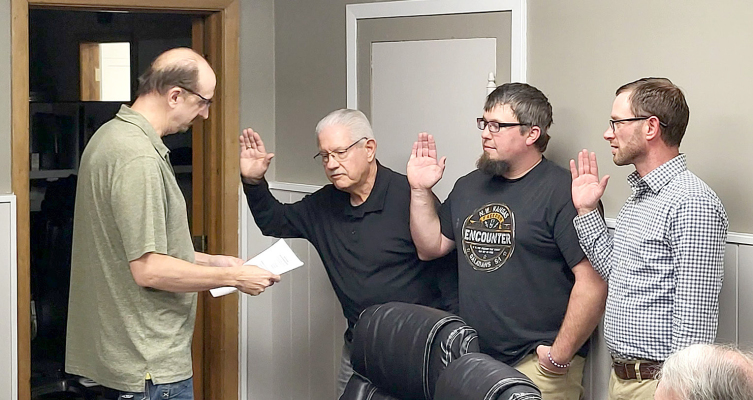 NEW MAYOR TOM NUCKOLS, along with new councilmen Skylar Rudman and Travis Dixon, are sworn in by City Clerk Jim Mesecher during the Plainville City Council meeting on Tuesday, January 20, at the city office. (Courtesy Photo)