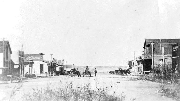 THIS IS A SNAPSHOT of Webster, Kansas, looking north in 1903. This image was turned into a postcard when the mail rate for postcards was just a penny. First-class letter postage was two cents. Postcards or postal cards held a special 1¢ rate established by Congress on July 1st, 1898.