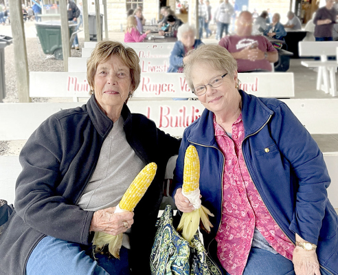 JOAN BALDERSTON and her niece, Janet McDowell enjoyed eating some roasted corn on Saturday evening of the Rooks County Free Fair. Janet, who resides in La Grand, Ore., makes sure her annual trek to Kansas to visit her aunt coincides with the Fair.
