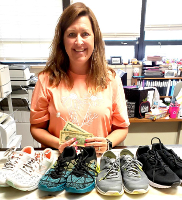 MANDI DOBSON, USD 269 Principal in Palco, was one of the three school districts in the county receiving some cash and slightly used athletic shoes from the event, Casual for a Cause, sponsored by the Rooks County Health Center.