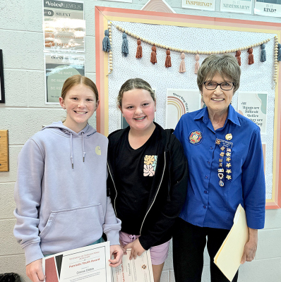 STOCKTON SIXTH-GRADE STUDENTS Tessa Look and Omree Dibble were recognized and honored with a Patriotic Youth Award by Stockton VFW Auxiliary President Deb Niermeier on Wednesday, September 11th (9/11) for their singing of our National Anthem during the Rooks County Free Fair. Pictured are (from left) Omree Dibble, Tessa Look, and Auxiliary President Deb Niermeier.
