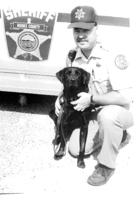 IN 1991, Rooks County Sheriff’s Department canine handler, Don Jenkins, Jr., and Kirby, a purebred black Lab, who specialized in sniffing out narcotics, had posed for a picture shortly after they had returned from their training school.