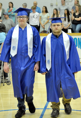 SENIORS ETHAN DAY and Cheston Bandt walk in to Pomp and Circumstance at the 2022 Commencement held Saturday. 