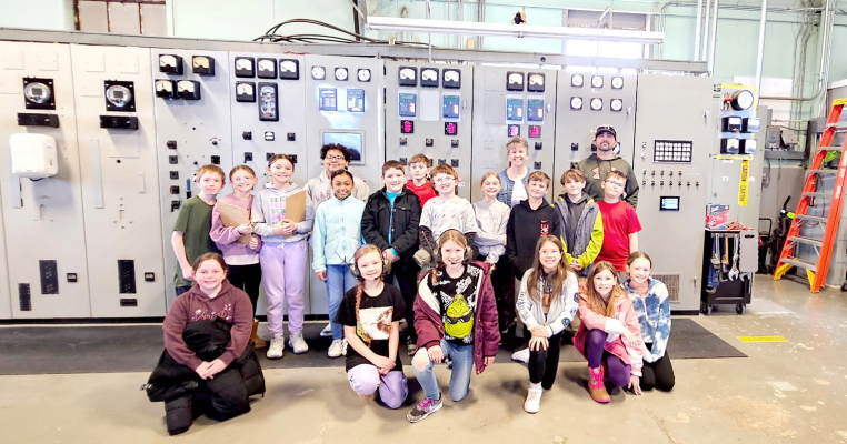 ENJOYING A TOUR OF THE STOCKTON POWER PLANT was Mrs. Fleck’s fourth grade class. Pictured are: (front row, from left) Kaisyn Muir, Penelope Chandler, Joree Dibble, Sophia Hanson, Abby Terry, Kynlee Collins; (middle row) Ira Beall, Norah Muir, Cambry Glendening, Treveah Clark, Levi Holsinger, Wyatt Barber, Emery Peterson, Cohen Muir, Karson Kuhlmann, Asher Lane; (back row) Kaiden Fast, Elijah Harp, Mrs. Fleck, and power plant superintendent Mitch Gibbs. (Not pictured is Kirby Cline.) (Courtesy Photo)