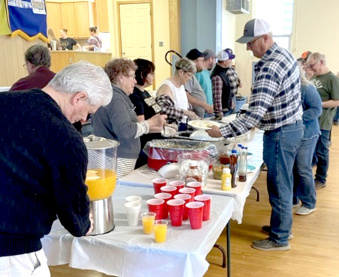 THE SERVING LINE was busy at the Pancake Supper.