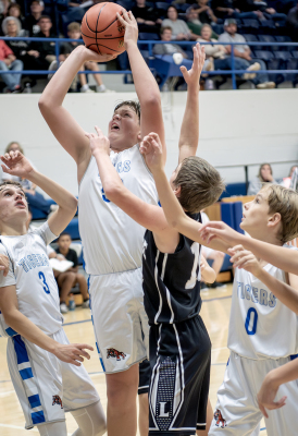 Hudson Muir goes up strong for a shot vs. Lakeside, while Lane Muir (#3) and Henry Berkley(#0) box out