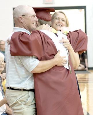 PHS SENIOR PEYTON KROB receives hugs from his parents, Jeremy and Amy Krob, during Commencement on May 16.