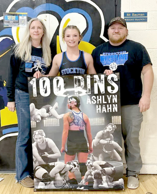 STOCKTON SENIORASHLYN HAHN reached 100 career pins at the Nickerson Tournament last Friday, reaching the milestone in 121 career wins. She is pictured with her parents Angela and Travis Hahn. Congratulations, Ashlyn! (Courtesy Photo)