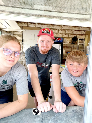Ready to serve up that great 4-H food including Whimpy burgers and Frito pies at this year’s Rooks County Free Fair are members of the County’s 4-H Groups. Pictured are (from left): Alessa Dinkle (Woodston Sunflower), Isaac Westhusin (Eager Beaver), and Damon Muir (Star). 