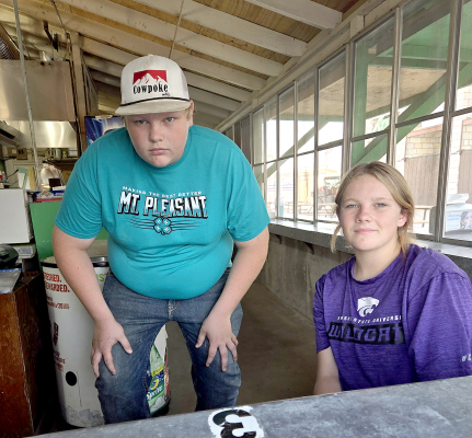 TAYLOR INGLSBEE AND KINLEY KESTER, with Mt. Pleasant 4-H, took their turn working the 4-H Food stand at the Rooks County Free Fair on Monday morning, August 5th.