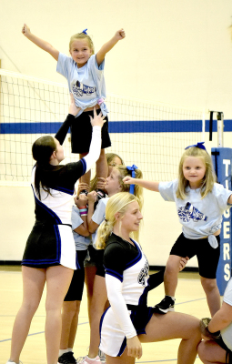 MARGARET BERKLEY (TOP LEFT) and Bailey Brass enjoyed getting to stunt with the help of the SHS Cheer Squad at Tiger Nation’s Back-To-School Bash on August 15.