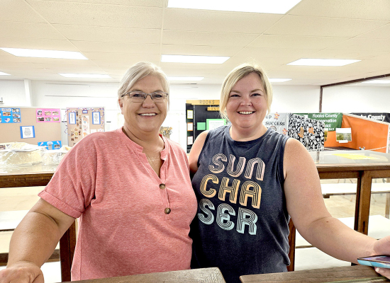 JANEL ODLE AND KINSEY POST helped check in the baked goods at the 4-H building during the first day of the Rooks County Free Fair.