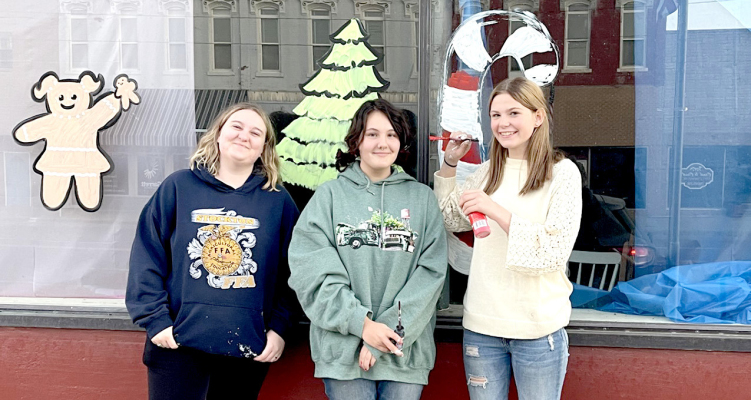 PAINTING THE BUSINESS WINDOWS for Stockton’s Olde Tyme Christmas were Raegan Shepherd, Piper Creighton, and Ariel Sager.