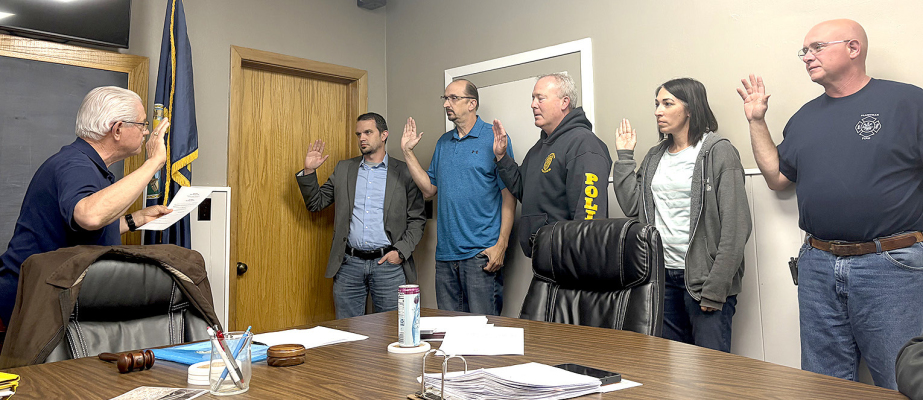 SWEARING IN HELD— From left: City Attorney Michael Baxter, City Administrator/Clerk Jim Mesecher, Police Chief Troy Rudman, Assistant City Clerk Mandy Bice, and Fire Chief Craig Wise are sworn in by Mayor Tom Nuckols during the Plainville City Council meeting on Tuesday, May 5. (Courtesy Photo)