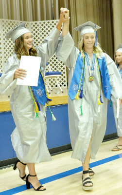FINALLY…WE DID IT! Just-graduated Tatum Hamilton (left) and Ellie Bellerive celebrate the moment at Saturday evening’s grad ceremony.