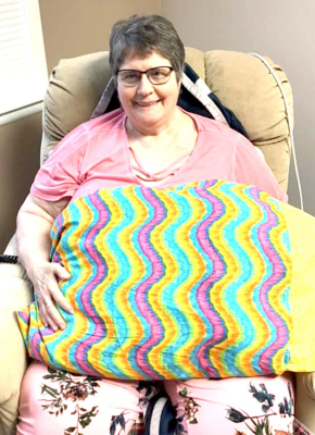 SUNSHINE IN A PILLOWCASE is what the St. Thomas Mission Quilters delivered to residents of Solomon Valley Manor such as the one held by resident Judy Thompson.