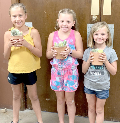 THE ROOKS COUNTY 4-H YOUTH have had a busy last couple of months with the 4-H Junior Leaders having hosted several day camps. These girls are showig their creation from the Craft Day Camp held recently at the 4-H Building in Stockton. Pictured from left include: Harper Lowry, Remy Muir and Norah Muir.
