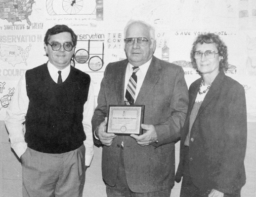 IN FEBRUARY 1989, Mitch Vandament of Osborne, representing J-J Oil of Woodston, is pictured on the left presenting the Goodyear Award to Gus and Helen Overley of rural Stockton.