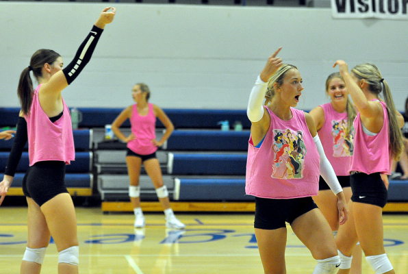 The Lady Tigers celebrate an ace while scrimmaging