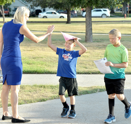 USD 271 SUPERINTENDENT Sarah Armstrong gives a high five to Grandon Mongeau as he and his brother, Grayson, enter the SGS building the first day of school on August 19.