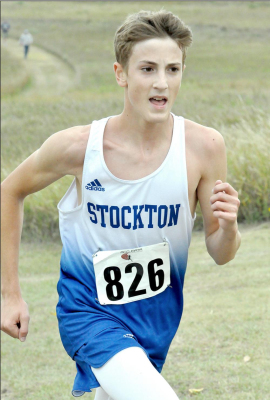 FRESHMAN JONATHAN HAMEL pushes himself as he runs up the hill on the way to a fourth-place finish at the cross country meet held at Webster State Park last Thursday.