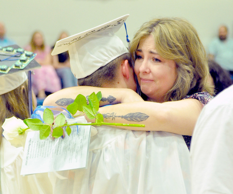 SHS GRADUATE Noah Ferguson receives a hug after giving his mother, Erika Thornburg a rose at Commencement.