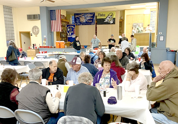 FOLKS IN THE COUNTY enjoyed a selection of four soups along with crackers, cheese, fruits, vegetables and desserts Sunday evening at the Palco Township Hall. The soup supper was sponsored by the Palco Lions Club. January is a great time to get together for visiting and a warm meal. Free will donations will support a variety of community projects. The three pictured in the middle of the photo include, from left, Kaylon Roberts, Tom Benoit, and Donna Benoit. (Courtesy Photo)