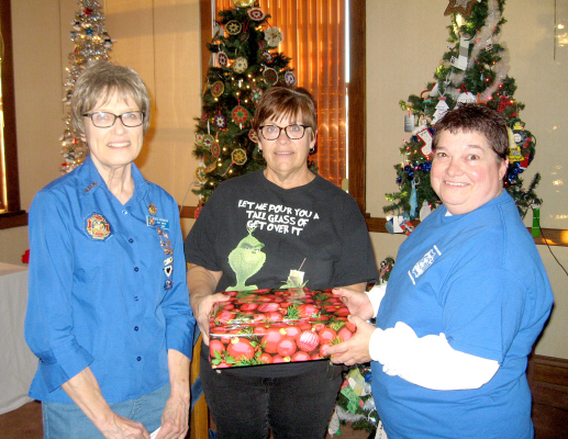 DEB NIERMEIER (left) and Dena Bouchey (right), members of the Stockton V.F.W. Auxiliary, donated books about our local veterans to the Stockton Public Library. This was given in honor of Stockton’s 150th Birthday and for all the veterans from this community that served our country. Deb and Dena are shown presenting one of the books to Chris Sander, librarian.