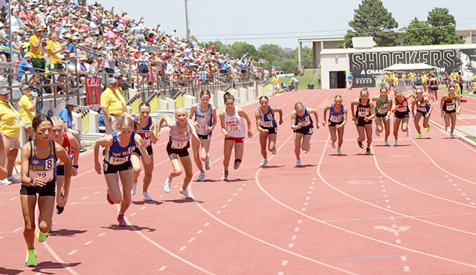 THE FIELD OF 16 RACERS for the 1600 Meter Run take off at the sound of the shotgun at the 2024 KSHSAA State Track and Field Championships held in Wichita. Stockton sophomore Cheyenne Hoeting (sixth from left) placed 10th in Saturday’s race. (Photo Courtesy of Jerry Clarke, Ness County News)